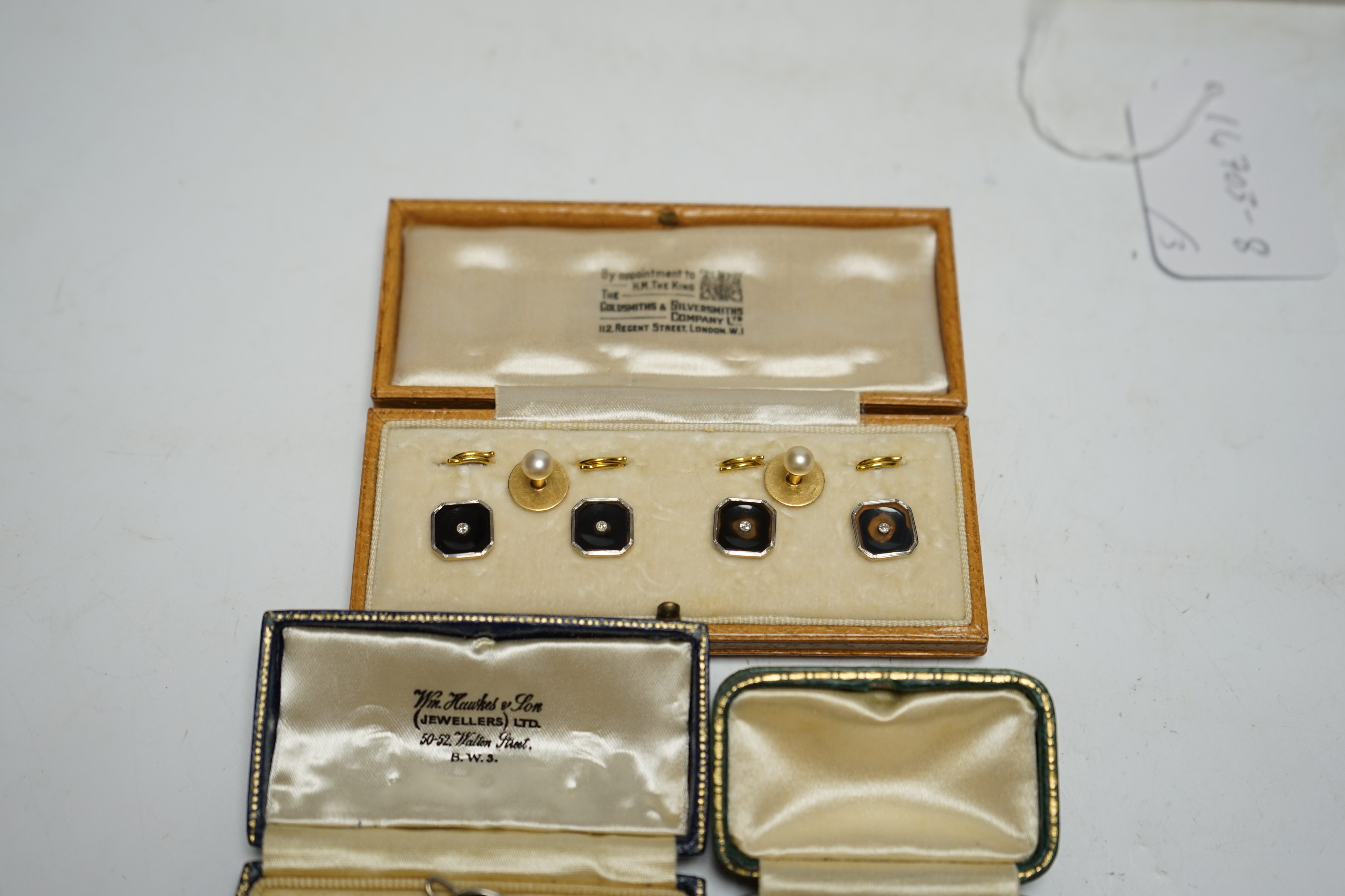 A cased set of four 18ct and plat. black onyx? and diamond set dress studs, two 18ct and cultured pearl set dress studs, four 9ct and plat. black onyx and seed pearl set dress studs and one other pair of 9ct and black on
